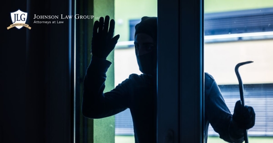 silhouette of a burglar outside a glass door